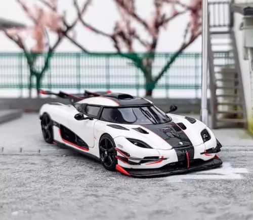 White 1:64 scale sports racing model car with black accents and red trim