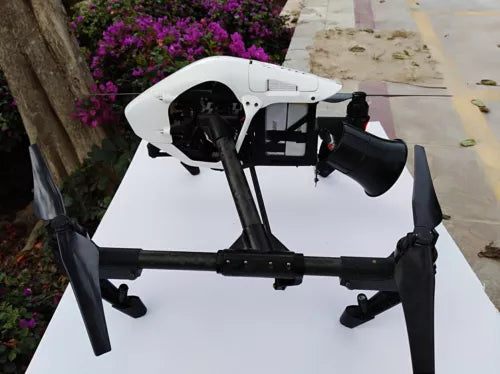 White drone with black wireless megaphone speaker horn