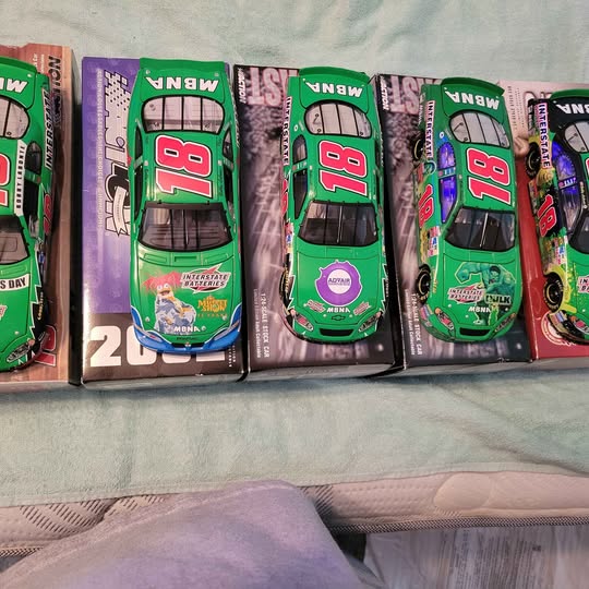 Diecast car in purple box with green, blue, and red racing car artwork