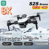 White quadcopter drone with four propellers and front camera module