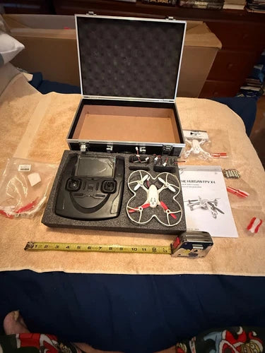 FPV RC quadcopter kit with controller, spare parts, and hard case, open view