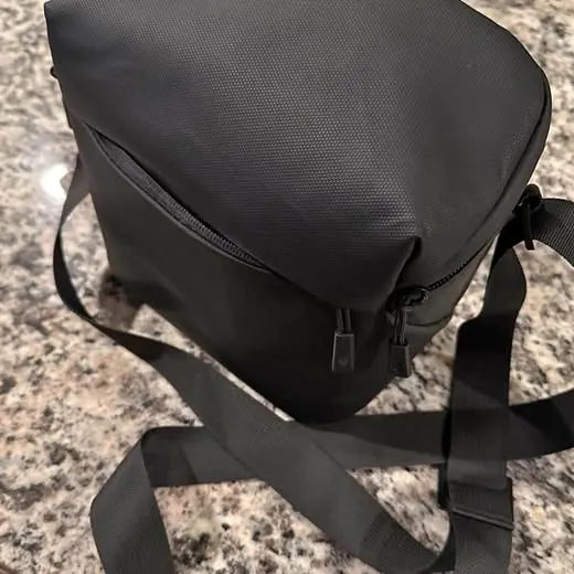 Black padded drone carry bag with shoulder strap and front zipper pocket