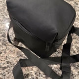 Black padded drone carry bag with shoulder strap and front zipper pocket