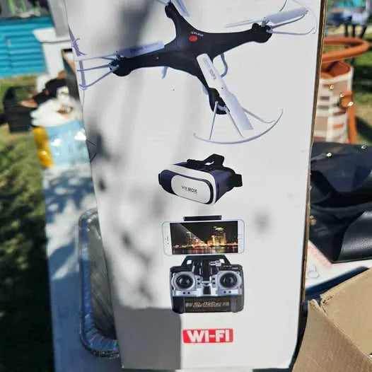 White drone packaging with quadcopter and remote controller, Wi‑Fi label