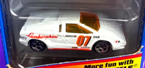 White diecast race car with orange stripe and number 07, black wheels.