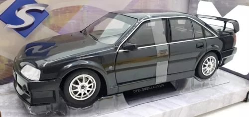 1:18 scale diecast sedan model, dark grey with white wheel rims