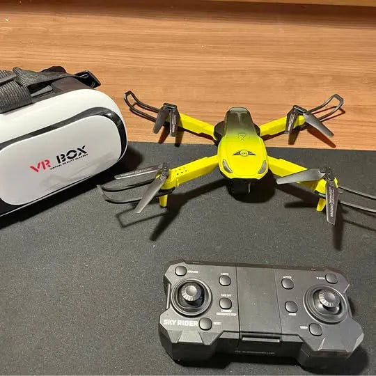 Yellow quadcopter drone with black arms and a gray controller