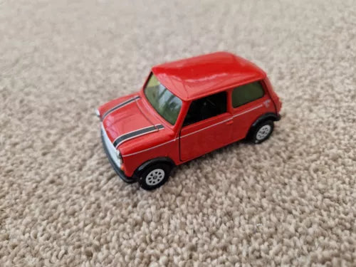 Red Mini Cooper diecast model car with white racing stripes and black wheels