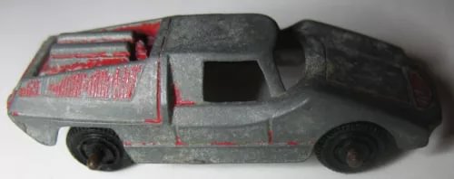 Diecast toy racing car with gray body and red stripes, side view.