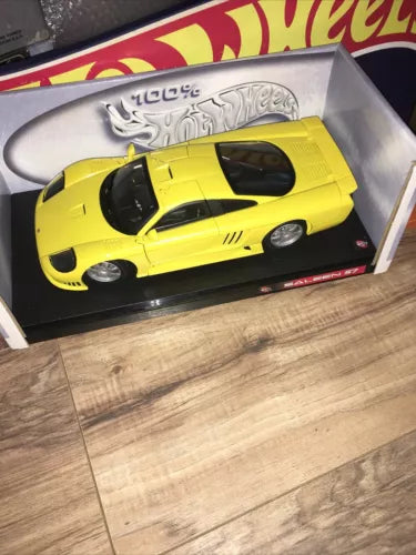 Yellow diecast collectible sports coupe with black accents, in display box