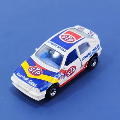 1:57 scale diecast racing car model, white and blue with STP and Vauxhall decals.