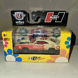M2 diecast car in yellow floral display box, clear window showing red Hurst-style car