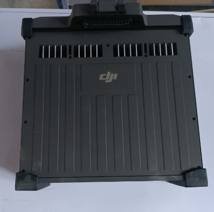DJ drone battery pack with handle, vents and connector ports, black
