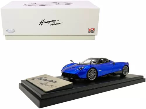 Blue diecast roadster model car with carbon-look accents on display base