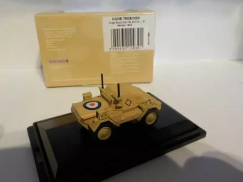 Diecast military scout car model on display base, yellow-olive with insignia.
