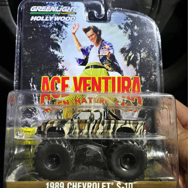 Diecast pickup truck model in blister pack, yellow and black camouflage, 1989 Chevrolet S-10.