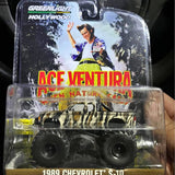 Diecast pickup truck model in blister pack, yellow and black camouflage, 1989 Chevrolet S-10.