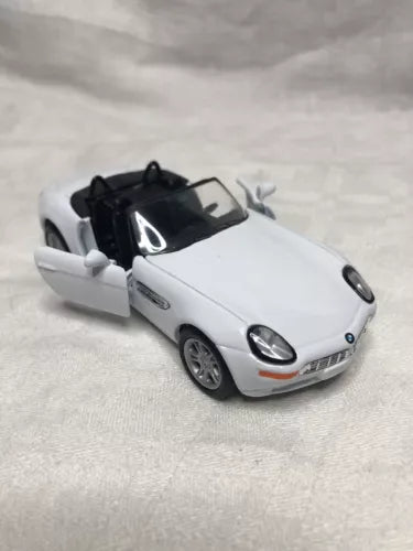 White 1:36 scale diecast convertible toy car with black open top, front 3/4 view