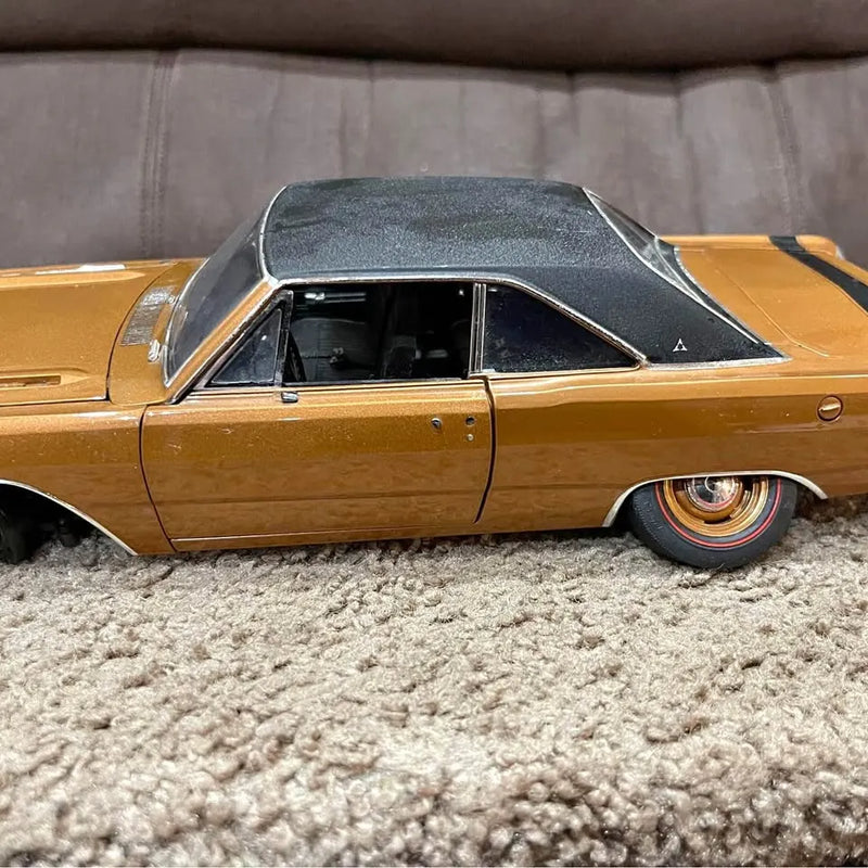 Gold diecast classic car with black roof, chrome trim, side profile, accented wheels