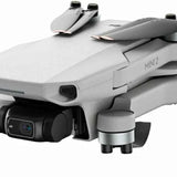 Gray mini drone with front camera lens and sensor, showing propeller arms