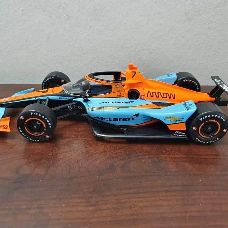 Diecast Indycar model race car in orange and blue with front wing and black wheels