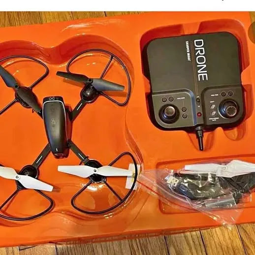 Orange drone starter kit with controller and quadcopter drone