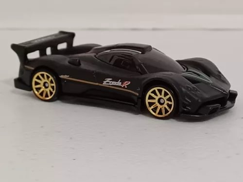 Black Zonda R diecast sports car with gold rims, rear wing, front splitter.