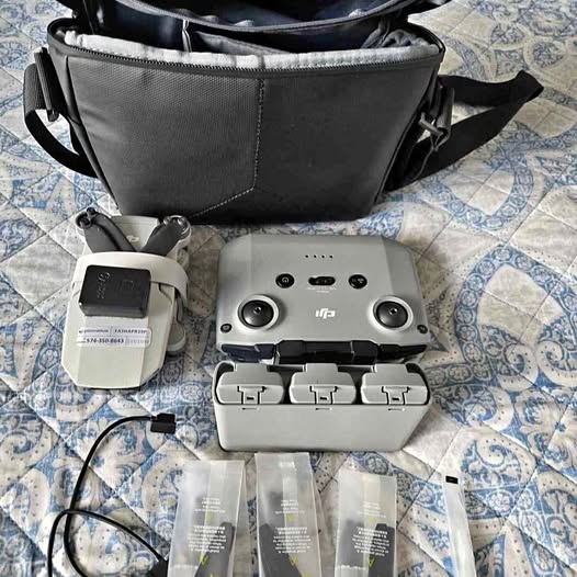 Portable drone charging hub, controller, and extra batteries in gray case