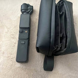 Black Dji Pocket 3 camera case with shoulder strap and open interior