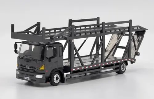 Gray diecast transport truck model with open frame and rail platform, cab facing left