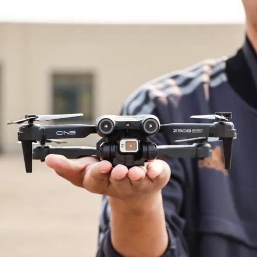 Mini quadcopter drone with front camera module and four propellers, silver and black