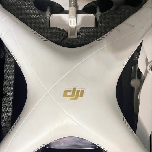 White DJI drone body with front arms and dji logo