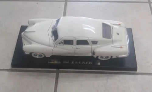 White 1:18 scale Tucker diecast car model on display base, detailed body