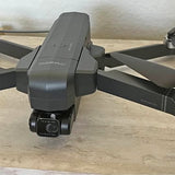 DEERC drone with 4K camera, front view, gray body with landing lights and camera lens