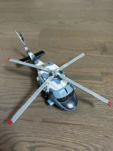 Light blue diecast helicopter toy with four white rotors and red tip accents