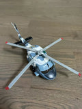 Light blue diecast helicopter toy with four white rotors and red tip accents