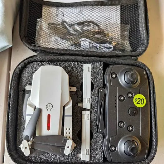 Drone and remote control in zippered hard case, with landing legs and charging accessories