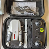 Drone and remote control in zippered hard case, with landing legs and charging accessories