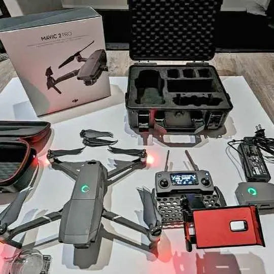 Gray quadcopter drone with controller and open storage case, propellers folded.