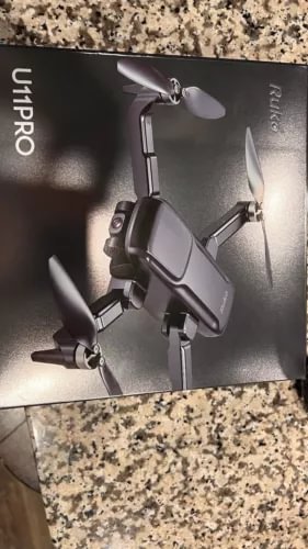 Foldable dark-gray drone with four propellers and front camera