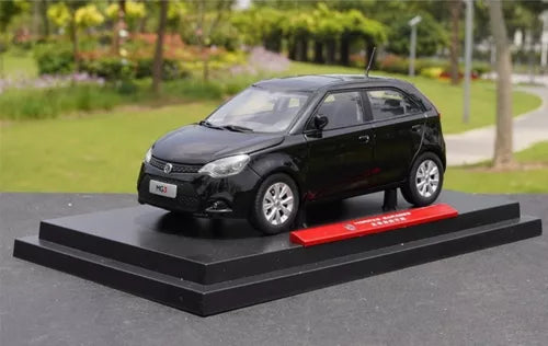 Black hatchback diecast car model on black display base, front three-quarter view