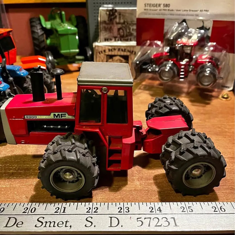 Red Massey Ferguson 4900 diecast tractor with large black tires and silver details