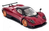 Red Pagani Zonda F diecast model car with orange wheels, front view