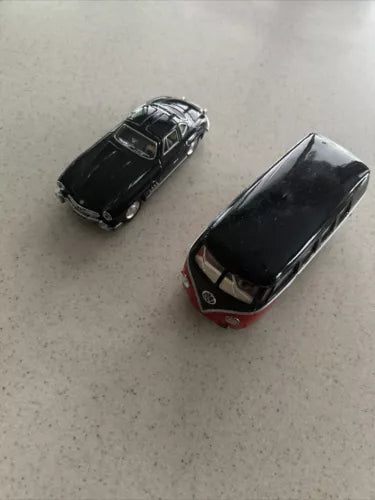 Pair of dark diecast toy cars, top view, 1:36 scale