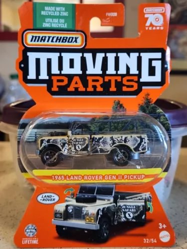 Diecast Land Rover pickup toy in retail blister pack, moving parts theme