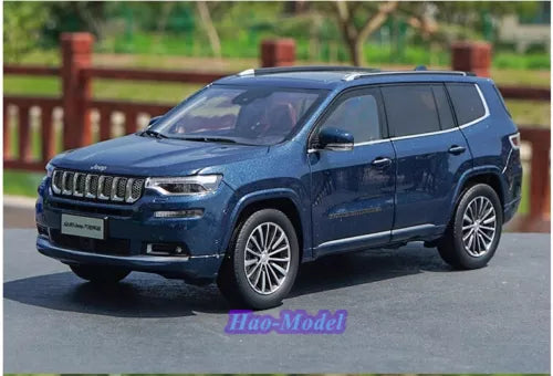 Blue diecast metal SUV car model with detailed grille and alloy wheels