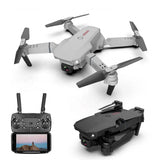 Foldable quadcopter drone with front camera and four propeller arms, plus controller screen