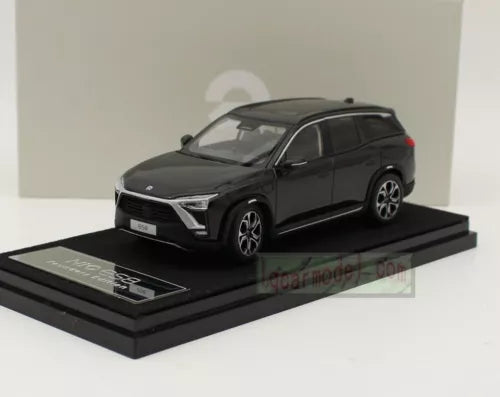 Black diecast car model, front three-quarter view on display base