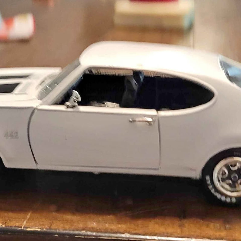 Pontiac 442 1:24 diecast car, white, front-side view with chrome wheels