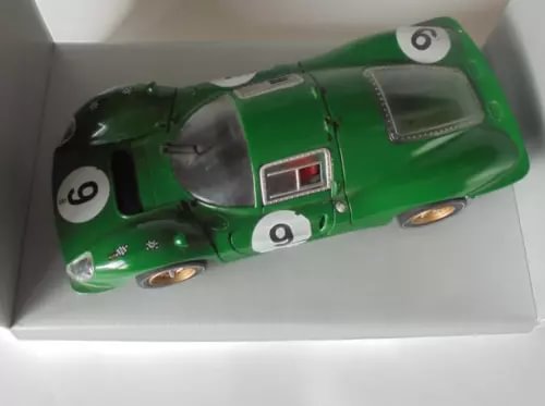 Green diecast race car model with white number 9 and cockpit window